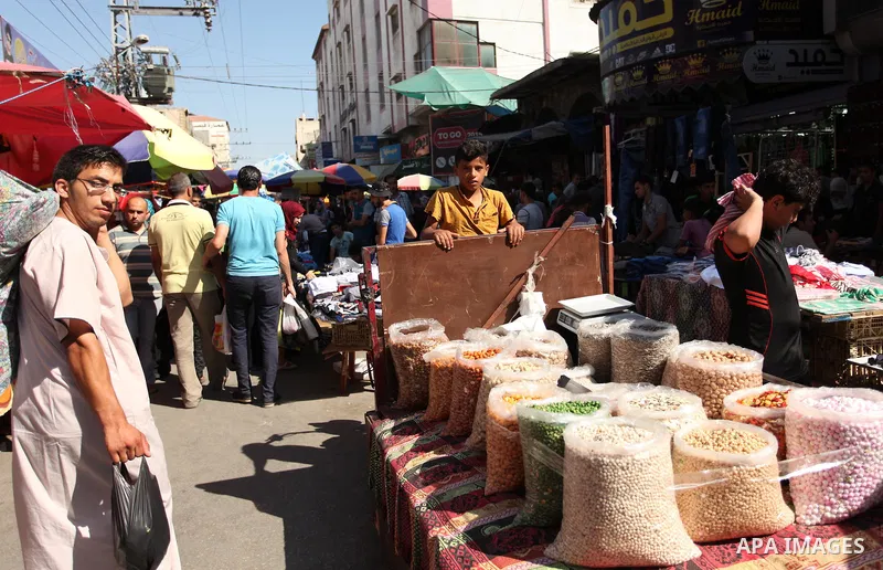 Palestinians shop at market ahead of the Eid al-Fitr holiday in Gaza city, on July 05, 2016, as Muslims the world over prepare to celebrate Eid al-Fitr, starting with the with the sighting of the new moon, to mark the en...