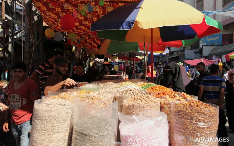 Palestinians shop at market ahead of the Eid al-Fitr holiday in Gaza city, on July 05, 2016, as Muslims the world over prepare to celebrate Eid al-Fitr, starting with the with the sighting of the new moon, to mark the en...