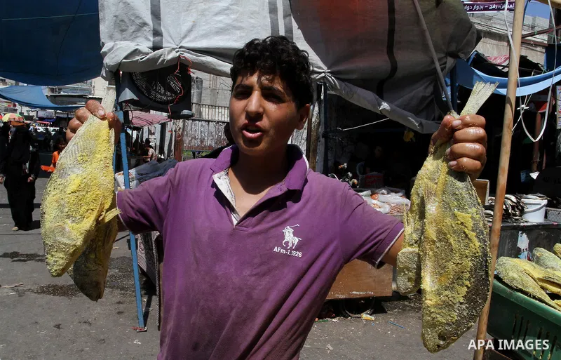 Palestinians shop at market ahead of the Eid al-Fitr holiday in Rafah in the southern Gaza strip, on July 05, 2016, as Muslims the world over prepare to celebrate Eid al-Fitr, starting with the with the sighting of the n...