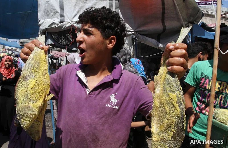 Palestinians shop at market ahead of the Eid al-Fitr holiday in Rafah in the southern Gaza strip, on July 05, 2016, as Muslims the world over prepare to celebrate Eid al-Fitr, starting with the with the sighting of the n...