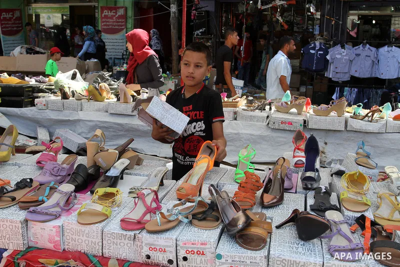 Palestinians shop at market ahead of the Eid al-Fitr holiday in Rafah in the southern Gaza strip, on July 05, 2016, as Muslims the world over prepare to celebrate Eid al-Fitr, starting with the with the sighting of the n...
