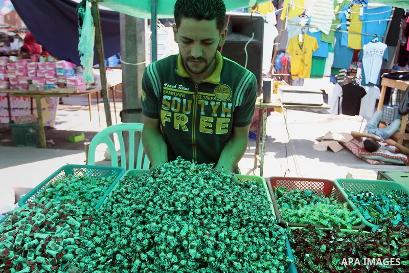 Palestinians shop at market ahead of the Eid al-Fitr holiday in Rafah in the southern Gaza strip, on July 05, 2016, as Muslims the world over prepare to celebrate Eid al-Fitr, starting with the with the sighting of the n...