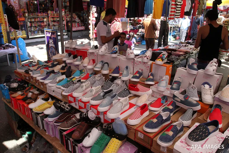 Palestinians shop at market ahead of the Eid al-Fitr holiday in Rafah in the southern Gaza strip, on July 05, 2016, as Muslims the world over prepare to celebrate Eid al-Fitr, starting with the with the sighting of the n...