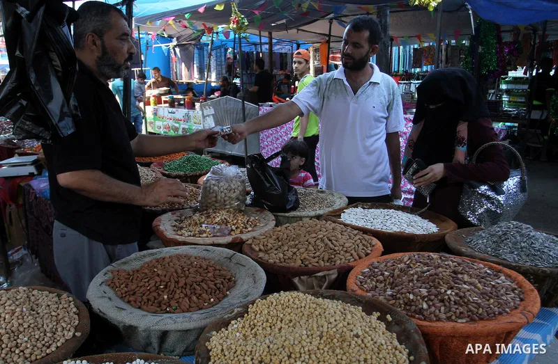 Palestinians shop at market ahead of the Eid al-Fitr holiday in Rafah in the southern Gaza strip, on July 05, 2016, as Muslims the world over prepare to celebrate Eid al-Fitr, starting with the with the sighting of the n...