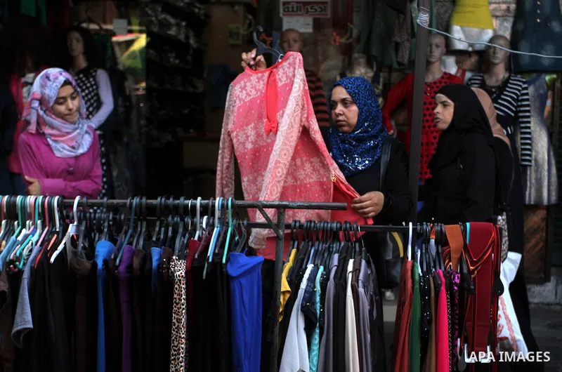Palestinians shop at market ahead of the Eid al-Fitr holiday in Rafah in the southern Gaza strip, on July 05, 2016, as Muslims the world over prepare to celebrate Eid al-Fitr, starting with the with the sighting of the n...