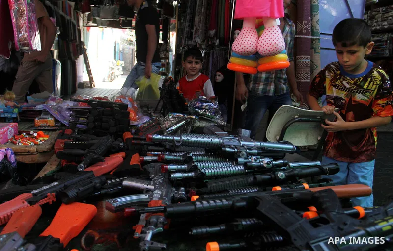 Palestinians shop at market ahead of the Eid al-Fitr holiday in Rafah in the southern Gaza strip, on July 05, 2016, as Muslims the world over prepare to celebrate Eid al-Fitr, starting with the with the sighting of the n...
