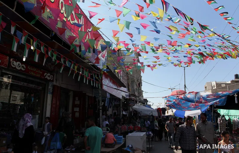 Palestinians shop at market ahead of the Eid al-Fitr holiday in Rafah in the southern Gaza strip, on July 05, 2016, as Muslims the world over prepare to celebrate Eid al-Fitr, starting with the with the sighting of the n...