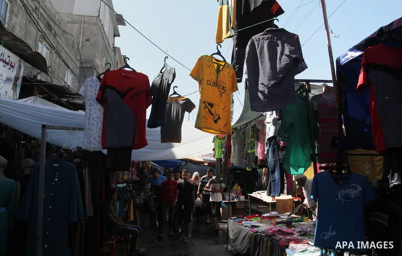 Palestinians shop at market ahead of the Eid al-Fitr holiday in Rafah in the southern Gaza strip, on July 05, 2016, as Muslims the world over prepare to celebrate Eid al-Fitr, starting with the with the sighting of the n...