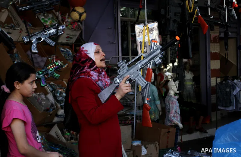 Palestinians shop at market ahead of the Eid al-Fitr holiday in Rafah in the southern Gaza strip, on July 05, 2016, as Muslims the world over prepare to celebrate Eid al-Fitr, starting with the with the sighting of the n...