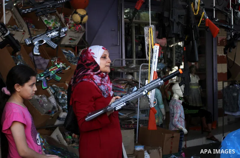 Palestinians shop at market ahead of the Eid al-Fitr holiday in Rafah in the southern Gaza strip, on July 05, 2016, as Muslims the world over prepare to celebrate Eid al-Fitr, starting with the with the sighting of the n...