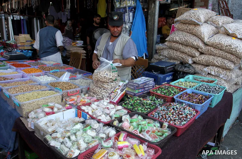 Palestinians shop at market ahead of the Eid al-Fitr holiday in Rafah in the southern Gaza strip, on July 05, 2016, as Muslims the world over prepare to celebrate Eid al-Fitr, starting with the with the sighting of the n...