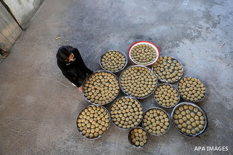 Palestinian girls prepare date-filled mini cakes traditional ahead of the Eid al-Fitr holiday in the West Bank city of Ramallah, on July 05, 2016, as Muslims the world over prepare to celebrate Eid al-Fitr, starting with...