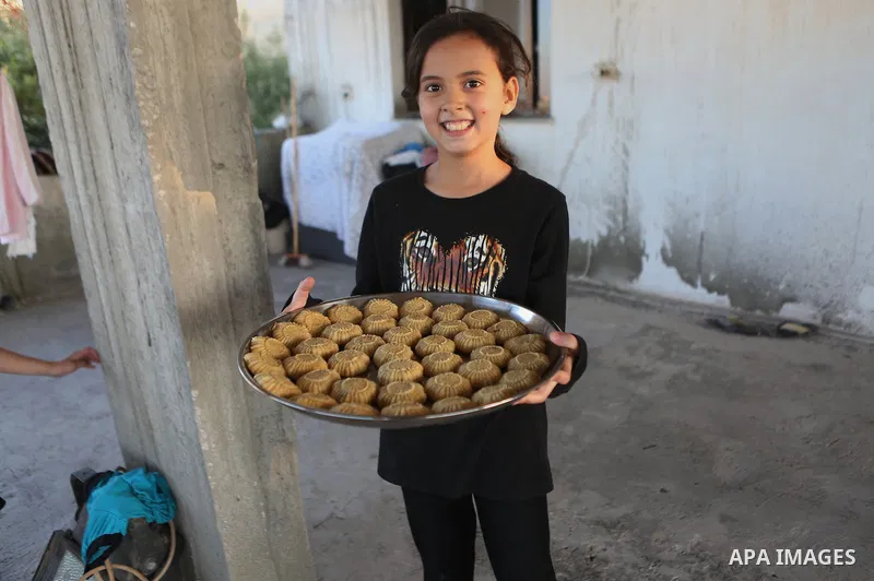 A Palestinian girl prepares date-filled mini cakes traditional ahead of the Eid al-Fitr holiday in the West Bank city of Ramallah, on July 05, 2016, as Muslims the world over prepare to celebrate Eid al-Fitr, starting wi...