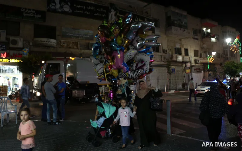 Palestinians shop at market ahead of the Eid al-Fitr holiday in the West Bank city of Ramallah, on July 05, 2016, as Muslims the world over prepare to celebrate Eid al-Fitr, starting with the with the sighting of the new...