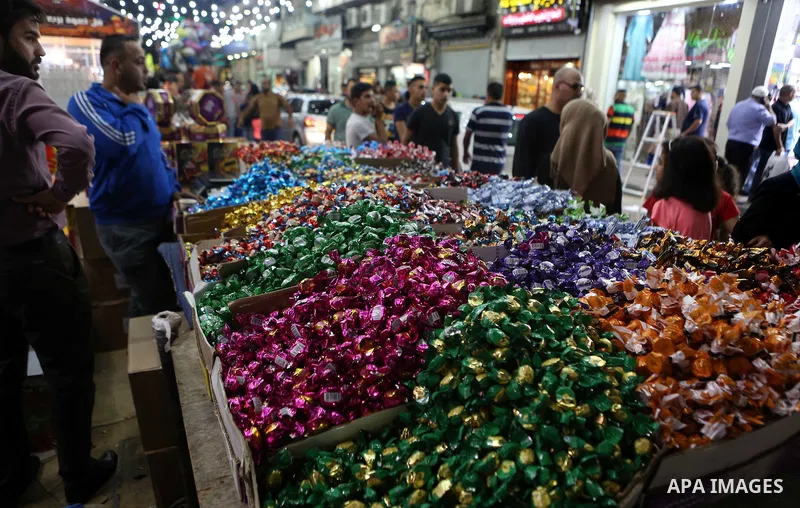 Palestinians shop at market ahead of the Eid al-Fitr holiday in the West Bank city of Ramallah, on July 05, 2016, as Muslims the world over prepare to celebrate Eid al-Fitr, starting with the with the sighting of the new...