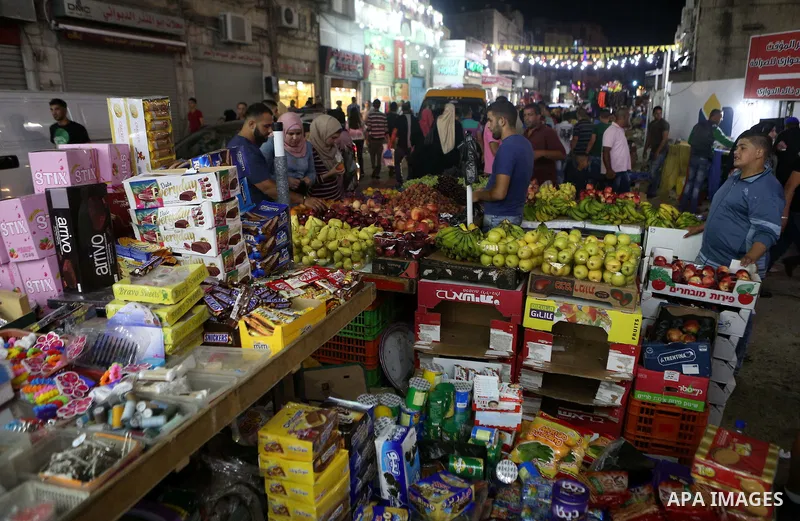 Palestinians shop at market ahead of the Eid al-Fitr holiday in the West Bank city of Ramallah, on July 05, 2016, as Muslims the world over prepare to celebrate Eid al-Fitr, starting with the with the sighting of the new...