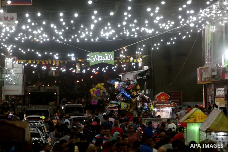 Palestinians shop at market ahead of the Eid al-Fitr holiday in the West Bank city of Ramallah, on July 05, 2016, as Muslims the world over prepare to celebrate Eid al-Fitr, starting with the with the sighting of the new...
