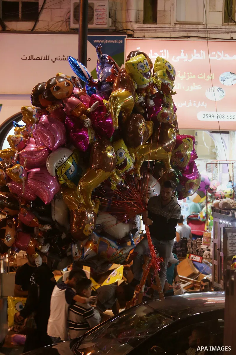 Palestinians shop at market ahead of the Eid al-Fitr holiday in the West Bank city of Ramallah, on July 05, 2016, as Muslims the world over prepare to celebrate Eid al-Fitr, starting with the with the sighting of the new...