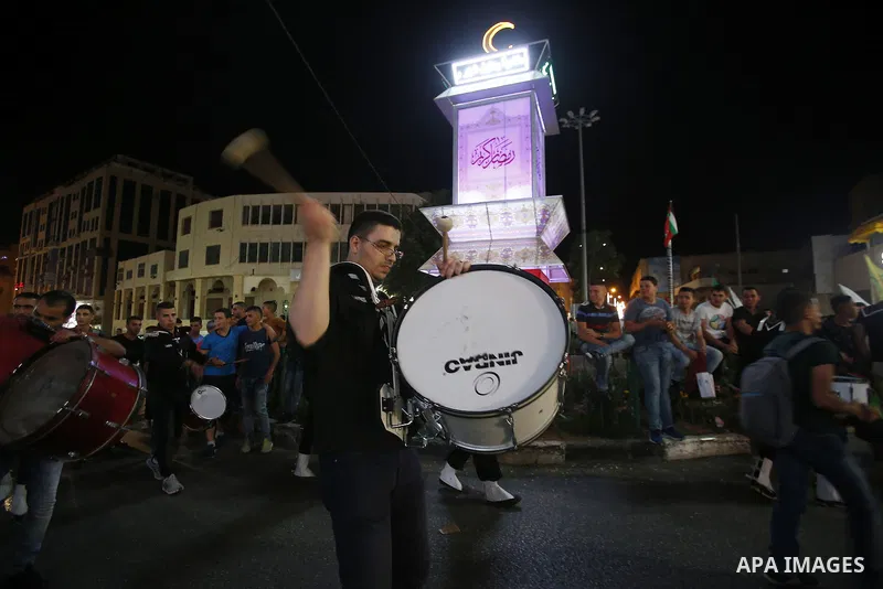 Palestinian scouts play music to celebrate for Eid al-Fitr holiday in the West Bank city of Hebron, on July 05, 2016, as Muslims the world over prepare to celebrate Eid al-Fitr, starting with the with the sighting of the...