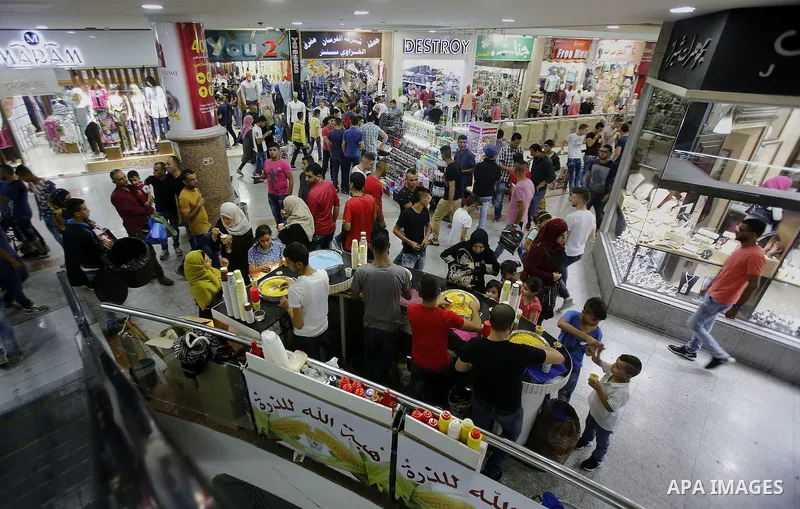 Palestinians shop at market ahead of the Eid al-Fitr holiday in the West Bank city of Hebron, on July 05, 2016, as Muslims the world over prepare to celebrate Eid al-Fitr, starting with the with the sighting of the new m...
