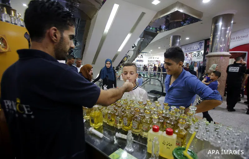 Palestinians shop at market ahead of the Eid al-Fitr holiday in the West Bank city of Hebron, on July 05, 2016, as Muslims the world over prepare to celebrate Eid al-Fitr, starting with the with the sighting of the new m...