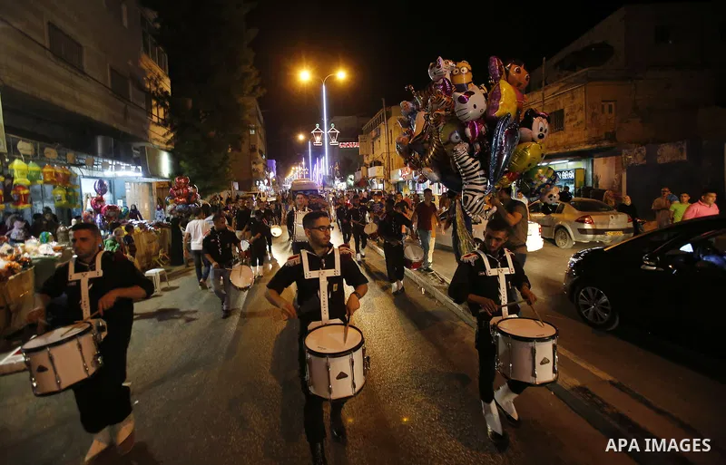 Palestinian scouts play music to celebrate for Eid al-Fitr holiday in the West Bank city of Hebron, on July 05, 2016, as Muslims the world over prepare to celebrate Eid al-Fitr, starting with the with the sighting of the...