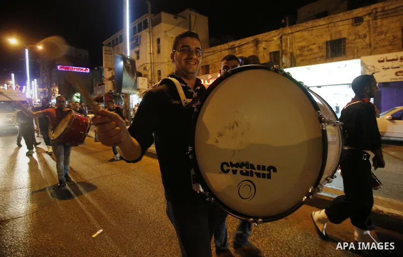 Palestinian scouts play music to celebrate for Eid al-Fitr holiday in the West Bank city of Hebron, on July 05, 2016, as Muslims the world over prepare to celebrate Eid al-Fitr, starting with the with the sighting of the...