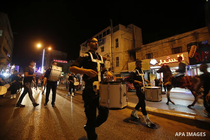 Palestinian scouts play music to celebrate for Eid al-Fitr holiday in the West Bank city of Hebron, on July 05, 2016, as Muslims the world over prepare to celebrate Eid al-Fitr, starting with the with the sighting of the...