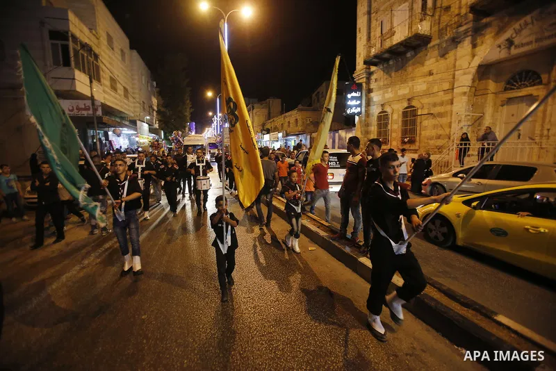 Palestinian scouts play music to celebrate for Eid al-Fitr holiday in the West Bank city of Hebron, on July 05, 2016, as Muslims the world over prepare to celebrate Eid al-Fitr, starting with the with the sighting of the...