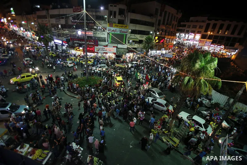 Palestinians shop at market ahead of the Eid al-Fitr holiday in the West Bank city of Hebron, on July 05, 2016, as Muslims the world over prepare to celebrate Eid al-Fitr, starting with the with the sighting of the new m...