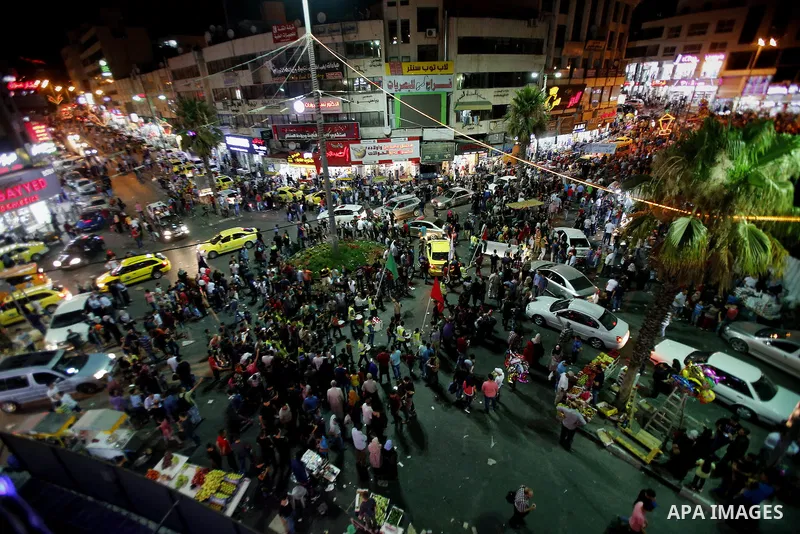Palestinians shop at market ahead of the Eid al-Fitr holiday in the West Bank city of Hebron, on July 05, 2016, as Muslims the world over prepare to celebrate Eid al-Fitr, starting with the with the sighting of the new m...