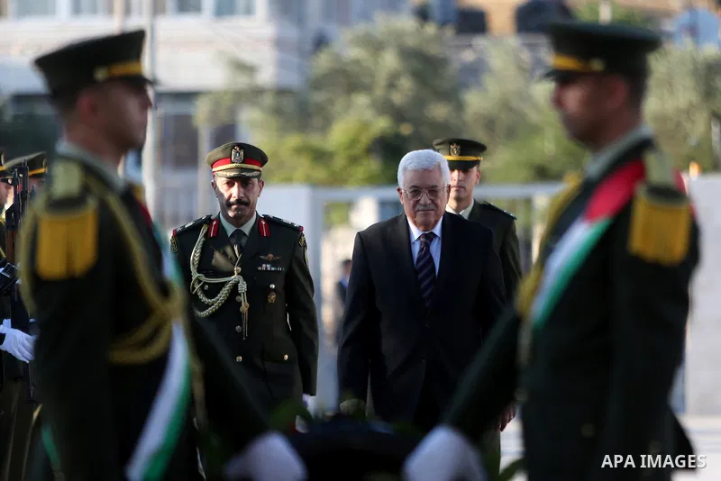 Palestinian President Mahmoud Abbas lays a wreath on the grave of late Palestinian leader Yasser Arafat on the first day of Eid al-Fitr celebrations, which marks the end of the holy fasting month of Ramadan, in the West...