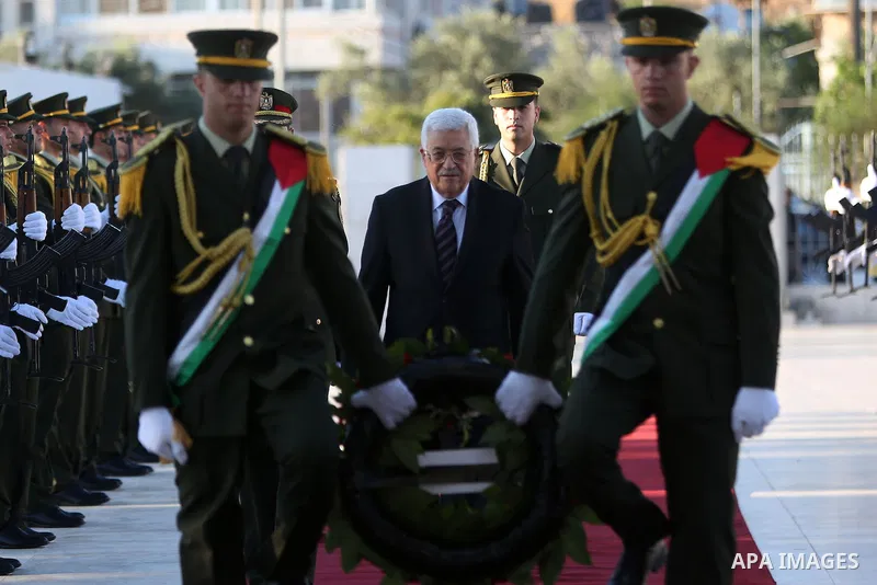 Palestinian President Mahmoud Abbas lays a wreath on the grave of late Palestinian leader Yasser Arafat on the first day of Eid al-Fitr celebrations, which marks the end of the holy fasting month of Ramadan, in the West...