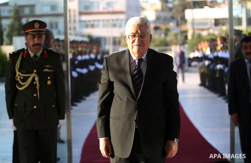 Palestinian President Mahmoud Abbas lays a wreath on the grave of late Palestinian leader Yasser Arafat on the first day of Eid al-Fitr celebrations, which marks the end of the holy fasting month of Ramadan, in the West...