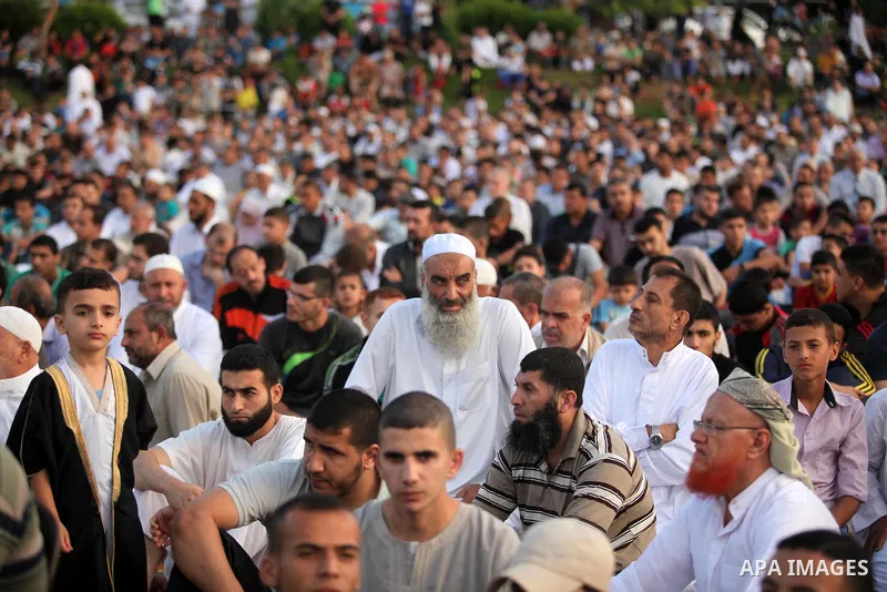 Palestinians attend the morning prayers for Eid al-Fitr celebrations, which marks the end of the holy fasting month of Ramadan, in Gaza City July 6, 2016. Photo by Ashraf Amra