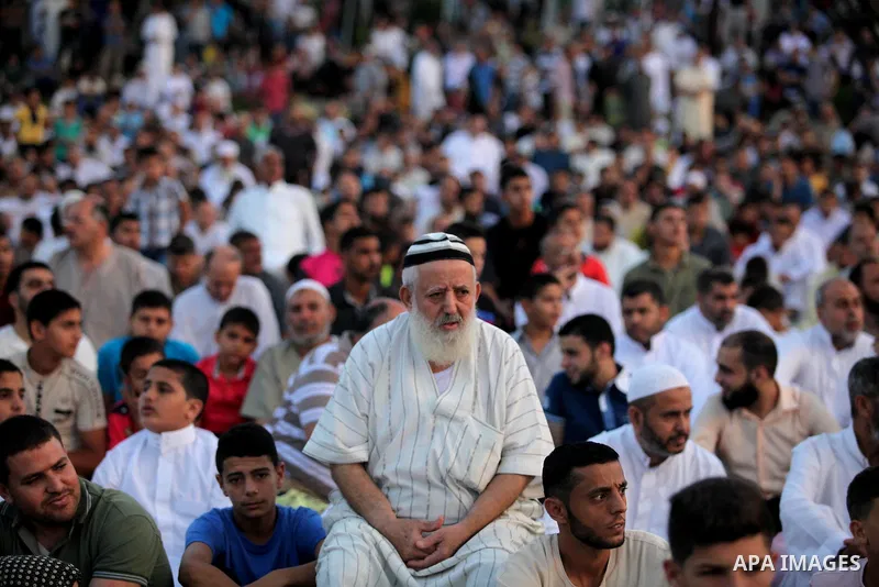 Palestinians attend the morning prayers for Eid al-Fitr celebrations, which marks the end of the holy fasting month of Ramadan, in Gaza City July 6, 2016. Photo by Ashraf Amra