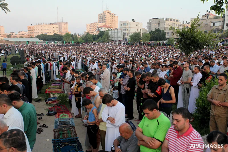 Palestinians attend the morning prayers for Eid al-Fitr celebrations, which marks the end of the holy fasting month of Ramadan, in Gaza City July 6, 2016. Photo by Ashraf Amra