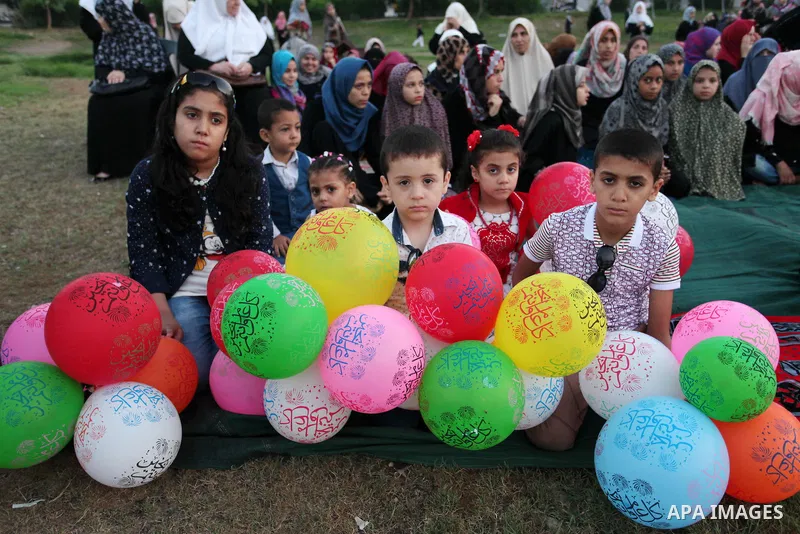 Palestinians attend the morning prayers for Eid al-Fitr celebrations, which marks the end of the holy fasting month of Ramadan, in Gaza City July 6, 2016. Photo by Ashraf Amra