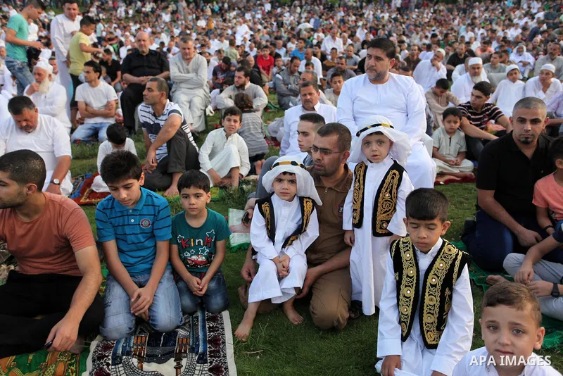 Palestinians attend the morning prayers for Eid al-Fitr celebrations, which marks the end of the holy fasting month of Ramadan, in Gaza City July 6, 2016. Photo by Ashraf Amra