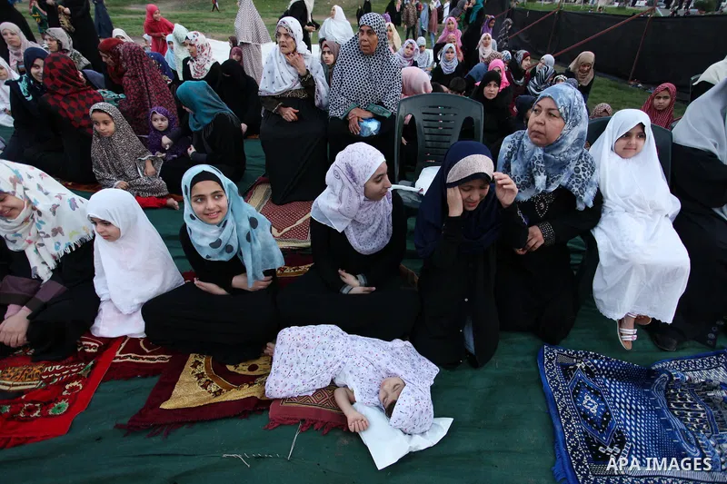 Palestinians attend the morning prayers for Eid al-Fitr celebrations, which marks the end of the holy fasting month of Ramadan, in Gaza City July 6, 2016. Photo by Ashraf Amra