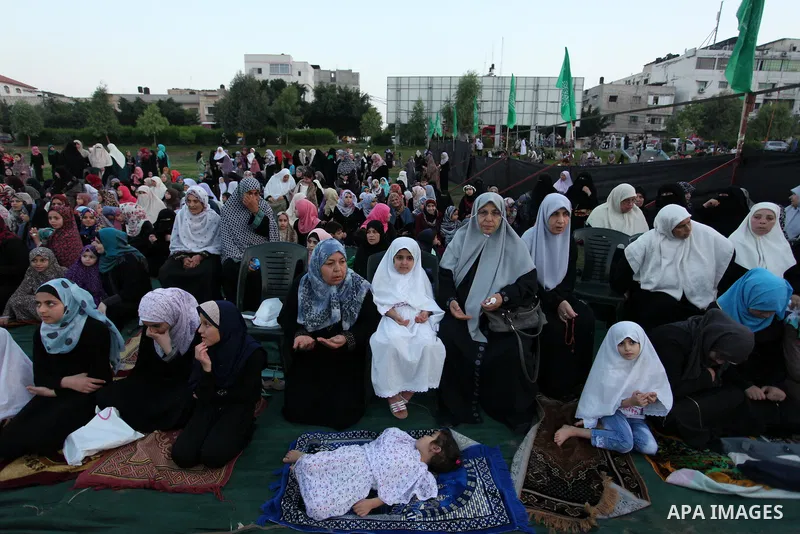 Palestinians attend the morning prayers for Eid al-Fitr celebrations, which marks the end of the holy fasting month of Ramadan, in Gaza City July 6, 2016. Photo by Ashraf Amra