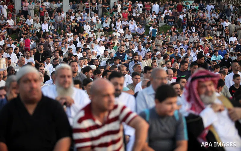 Palestinians attend the morning prayers for Eid al-Fitr celebrations, which marks the end of the holy fasting month of Ramadan, in Gaza City July 6, 2016. Photo by Ashraf Amra