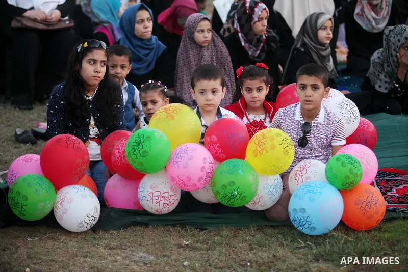 Palestinians attend the morning prayers for Eid al-Fitr celebrations, which marks the end of the holy fasting month of Ramadan, in Gaza City July 6, 2016. Photo by Ashraf Amra