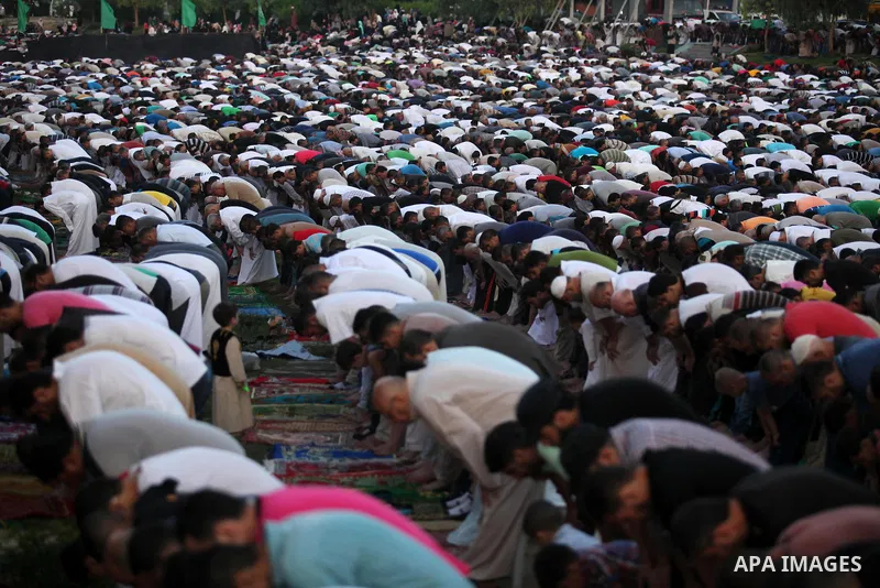 Palestinians attend the morning prayers for Eid al-Fitr celebrations, which marks the end of the holy fasting month of Ramadan, in Gaza City July 6, 2016. Photo by Ashraf Amra