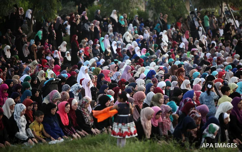 Palestinians attend the morning prayers for Eid al-Fitr celebrations, which marks the end of the holy fasting month of Ramadan, in Gaza City July 6, 2016. Photo by Ashraf Amra