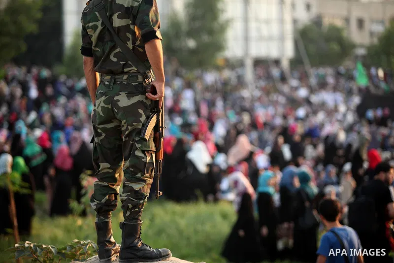 A member of Palestinian security forces loyal to Hamas stands guard during the morning prayers for Eid al-Fitr celebrations, which marks the end of the holy fasting month of Ramadan, in Gaza City July 6, 2016. Photo by A...