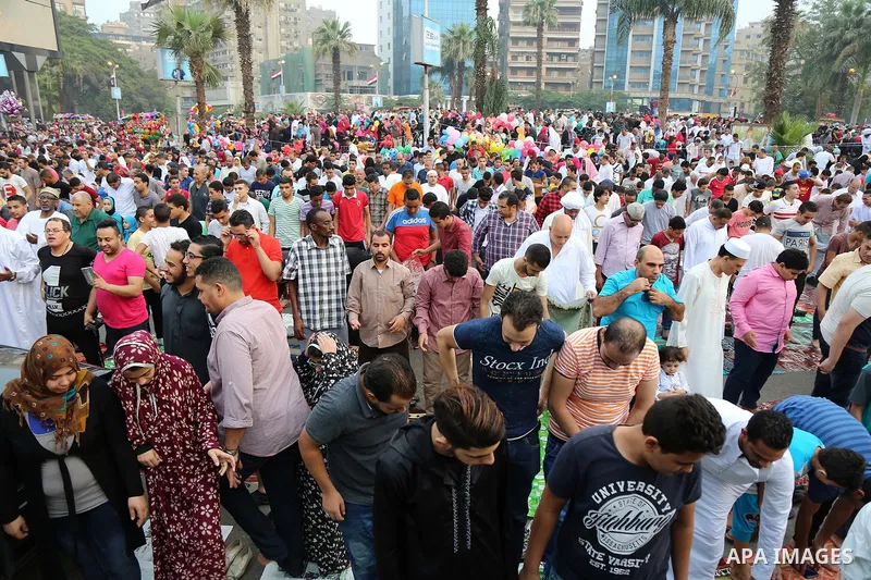 Egyptian Muslims attend the morning prayers for Eid al-Fitr celebrations, which marks the end of the holy fasting month of Ramadan, at Mustafa Mahmoud Squar, in Cairo, Egypt, on July 06, 2016. Photo by Amr Sayed