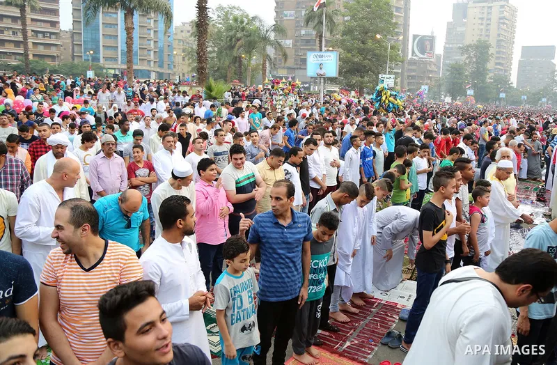 Egyptian Muslims attend the morning prayers for Eid al-Fitr celebrations, which marks the end of the holy fasting month of Ramadan, at Mustafa Mahmoud Squar, in Cairo, Egypt, on July 06, 2016. Photo by Amr Sayed