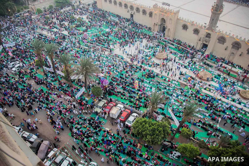 Egyptian Muslims attend the morning prayers for Eid al-Fitr celebrations, which marks the end of the holy fasting month of Ramadan, outside Amr Ibn El-Aas mosque, in Cairo, Egypt, on July 06, 2016. Photo by Amr Sayed