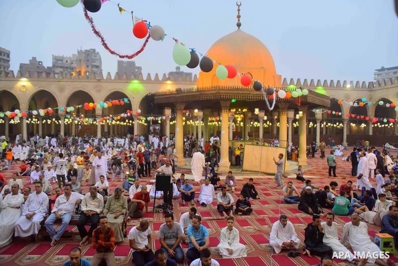 Egyptian Muslims attend the morning prayers for Eid al-Fitr celebrations, which marks the end of the holy fasting month of Ramadan, outside Amr Ibn El-Aas mosque, in Cairo, Egypt, on July 06, 2016. Photo by Amr Sayed